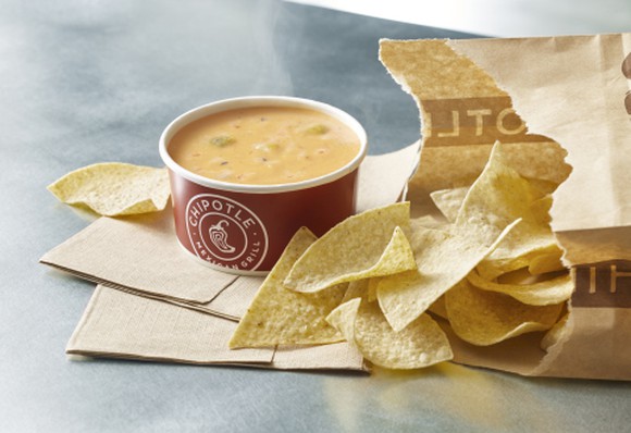 A bag of chips and Chipotle queso