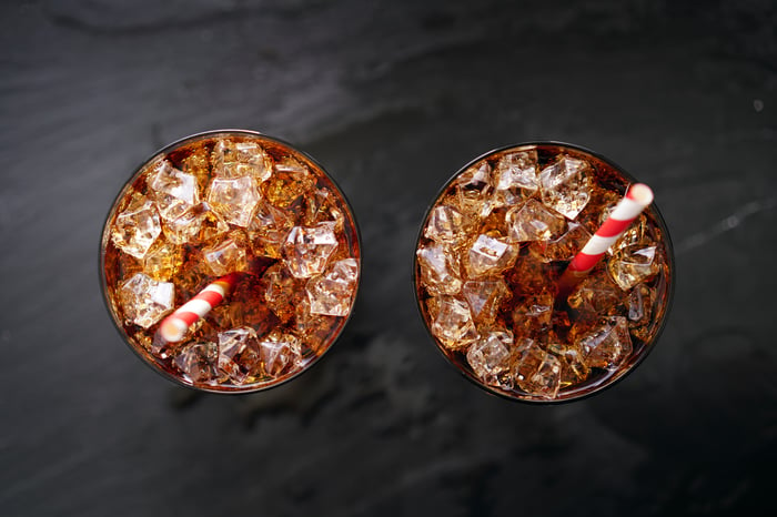 Two glasses viewed from above, filled with soda and ice