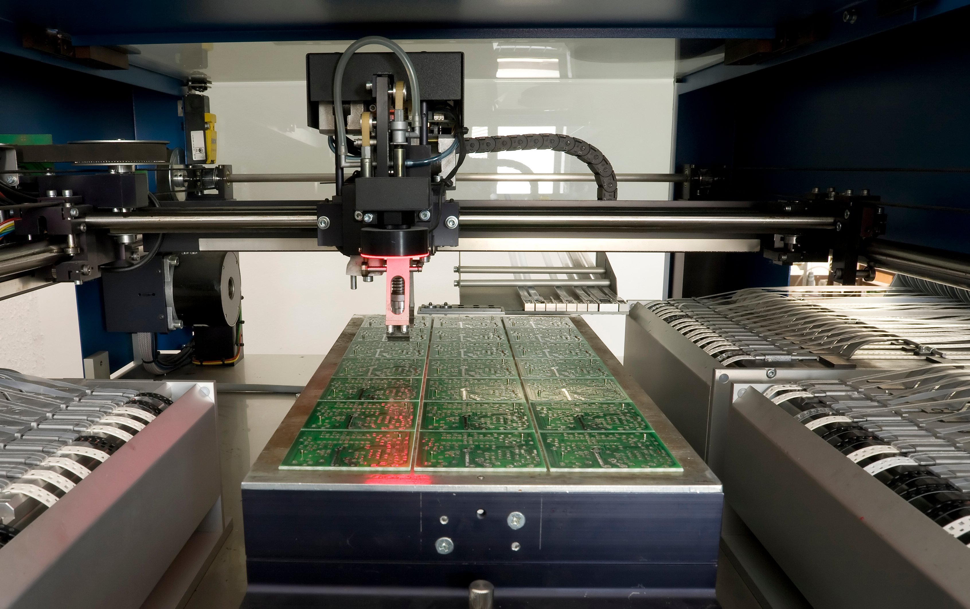Machines are producing a batch of printed circuit boards.