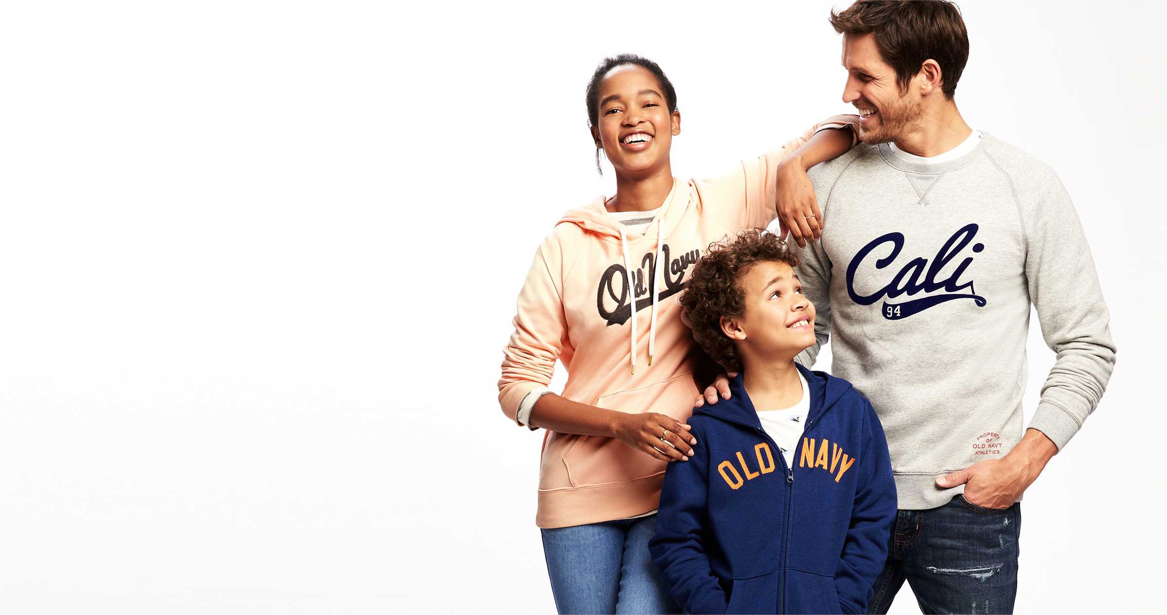 A man, teenage girl, and young boy posing together in Old Navy apparel.