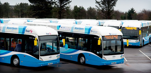 Hydrogen powered buses sitting in a parking lot.