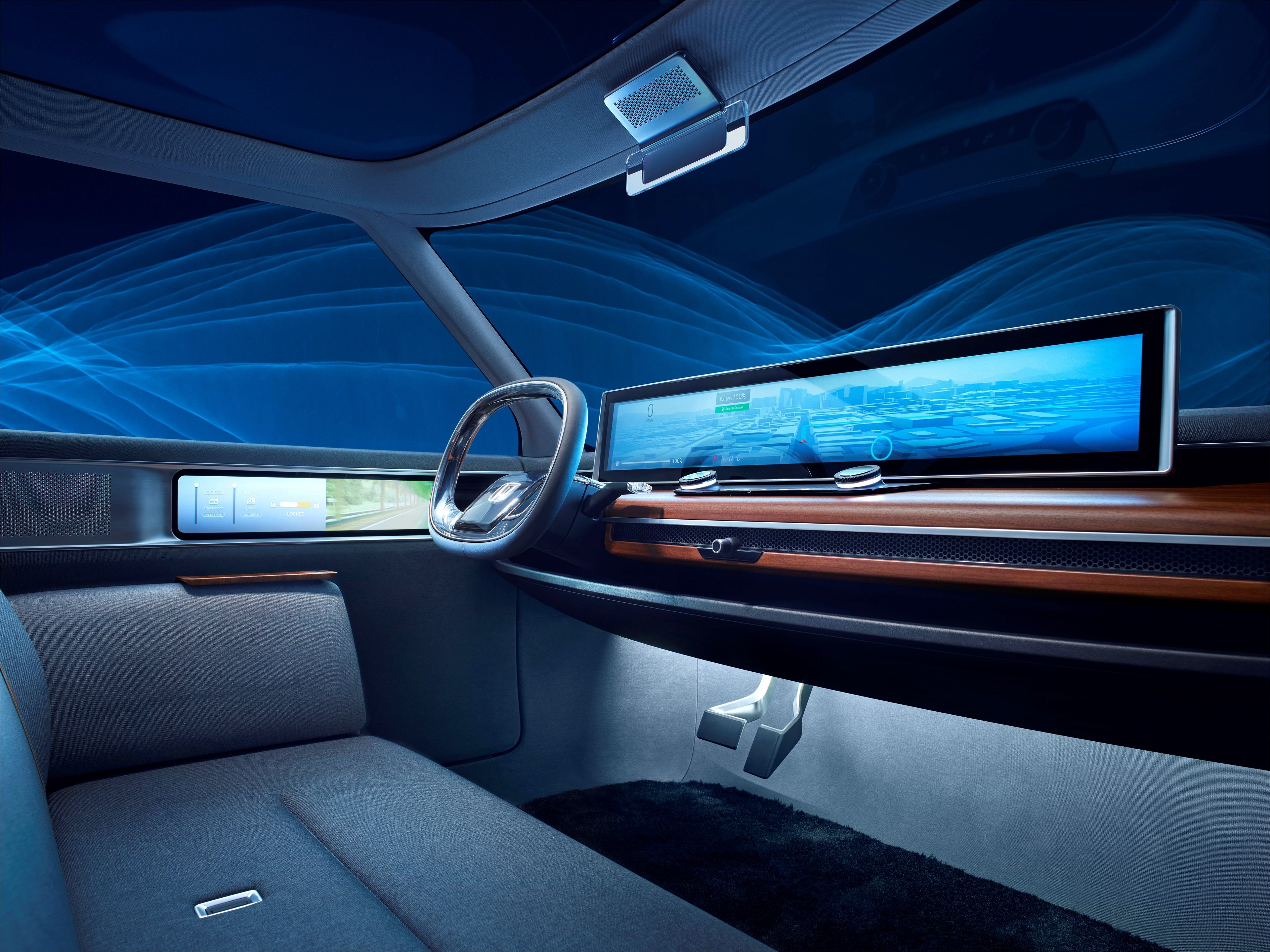 The dashboard and front seat of the Honda Urban EV Concept includes wood paneling, huge touchscreens, and couch-like seating.