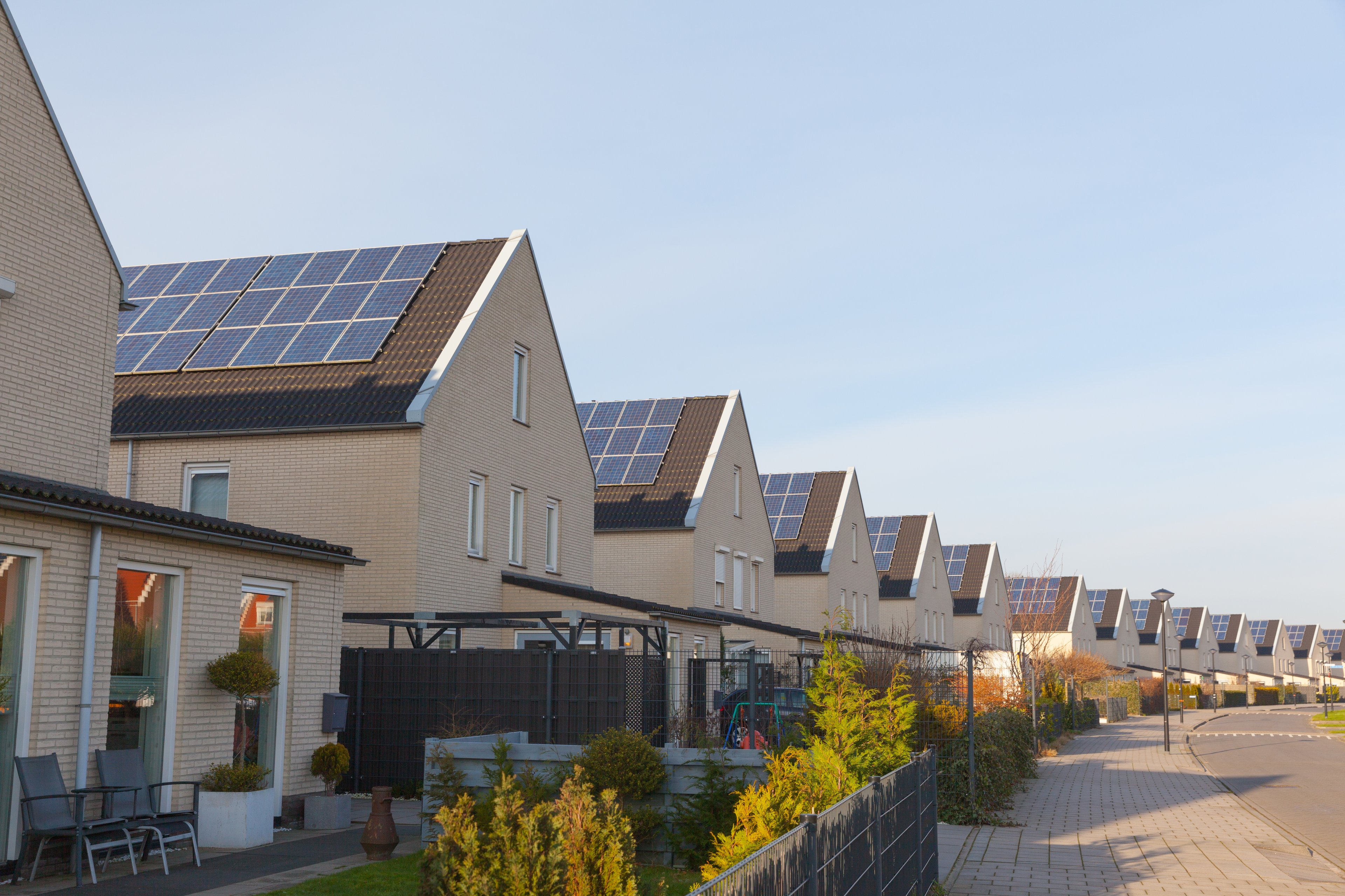 Row of homes with solar panels on their roofs.