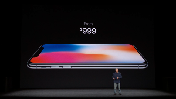 Phil Schiller standing in front of a display featuring an iPhone X with the words "From $999" above it.