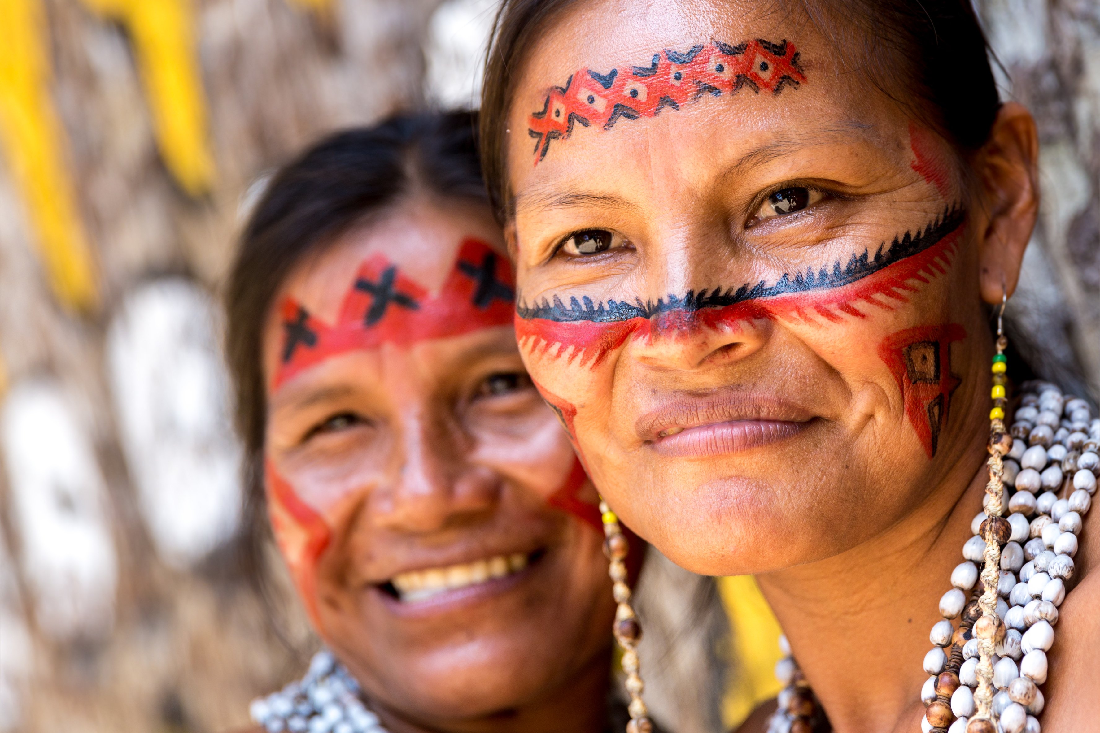 Two indigenous Brazilian women smiling. 