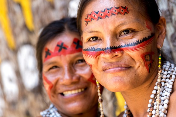 Two indigenous Brazilian women smiling. 