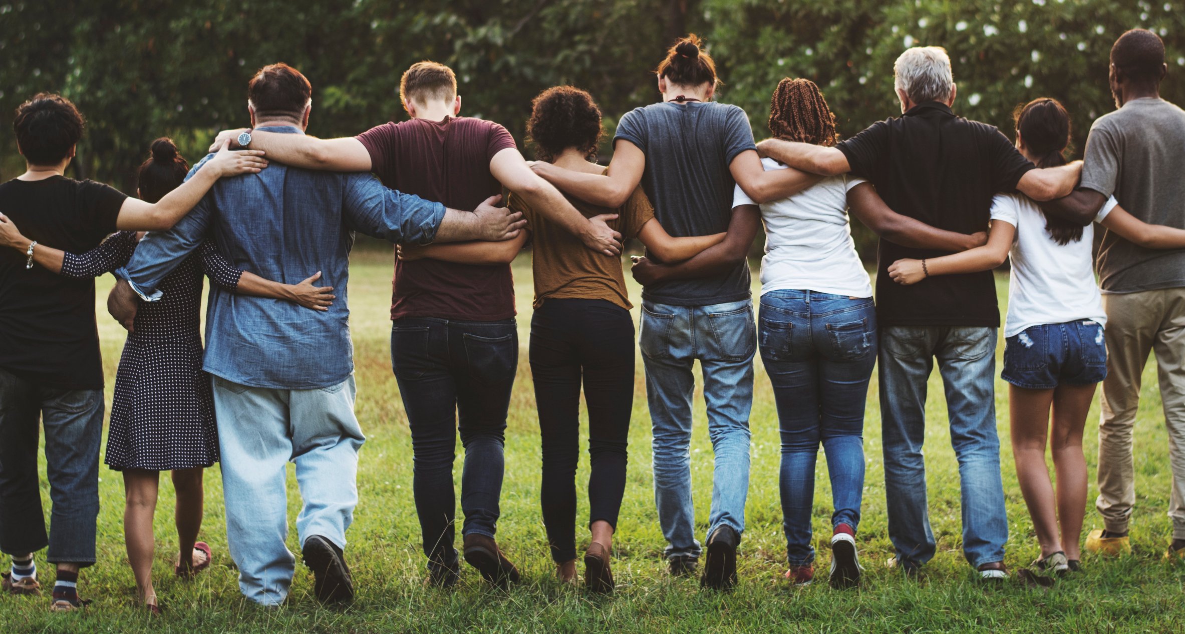 A group of friends walking with arms around each other