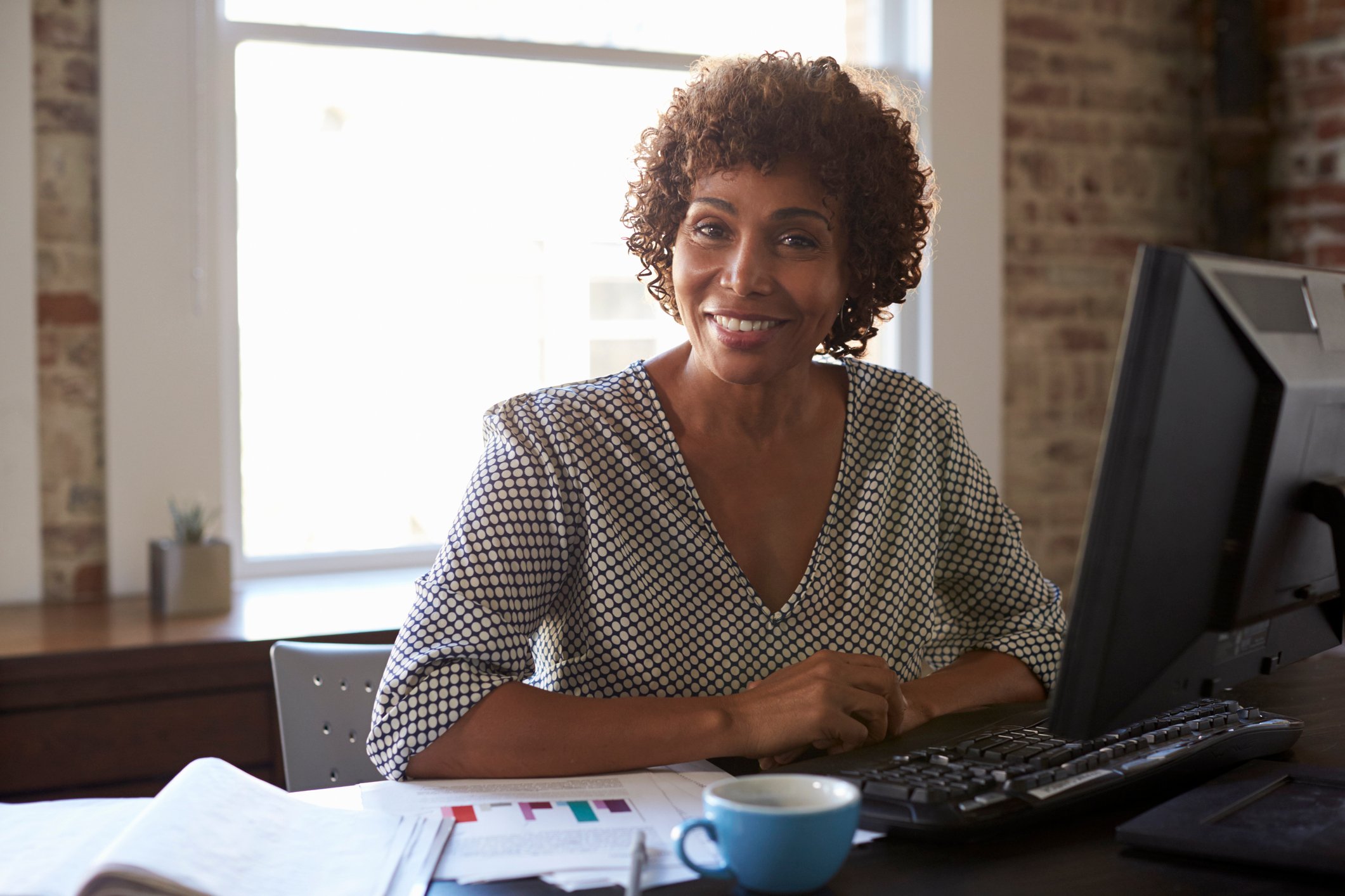 Woman at her computer, smiling
