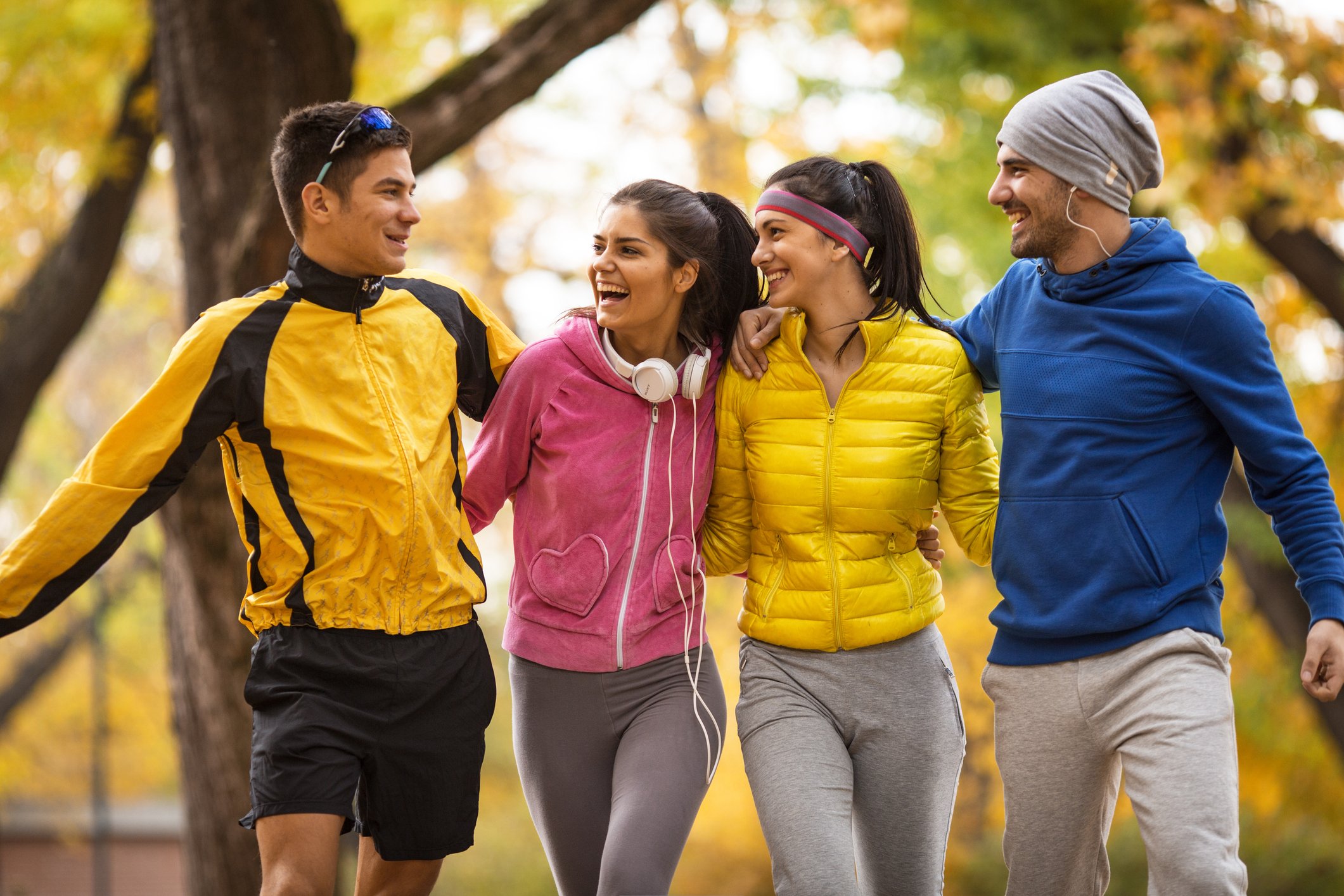 Group of friends walking together and wearing athletic apparel.