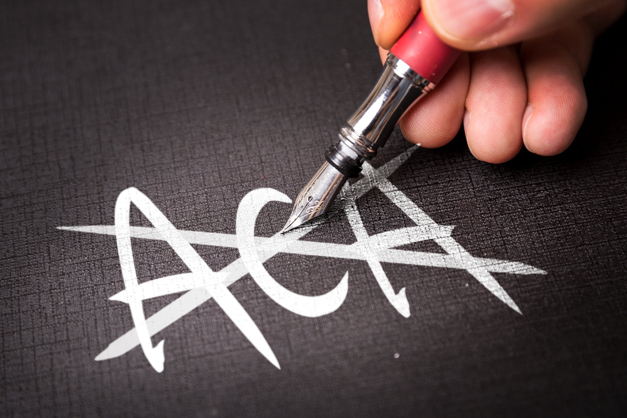 The letters "ACA" crossed out by a fountain pen.