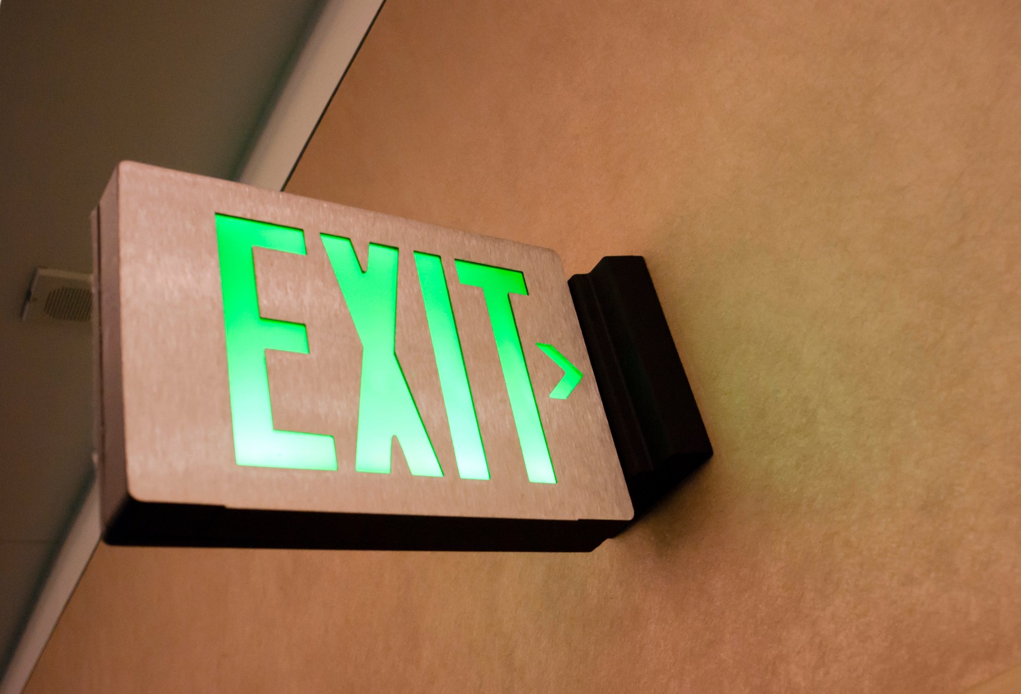 An exit sign attached to a wall. 