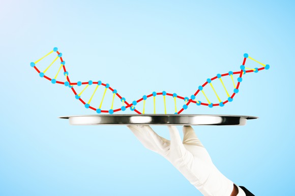A white-gloved hand holding a silver platter with a strand of DNA on it.