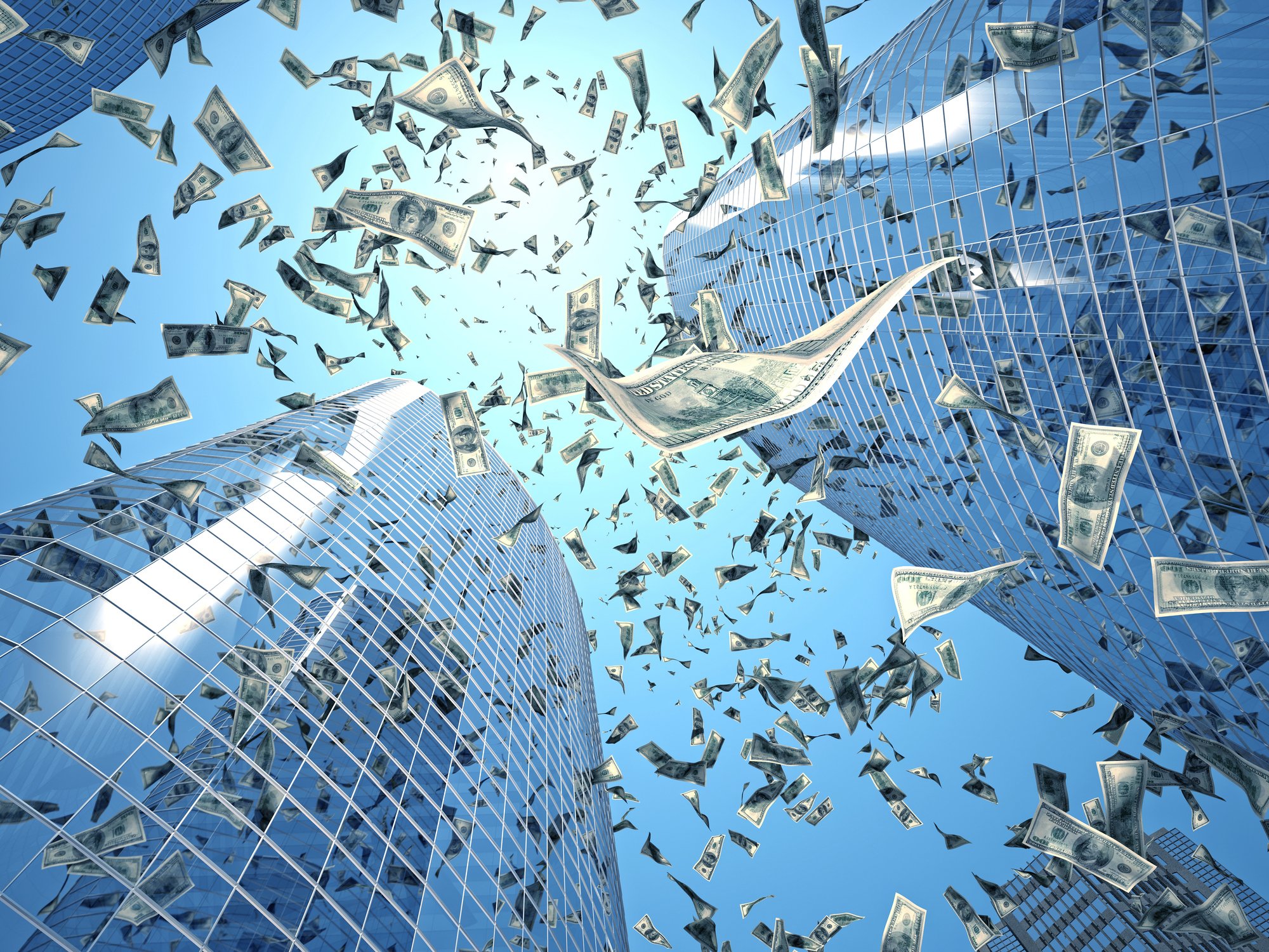 Money falling from sky between office buildings