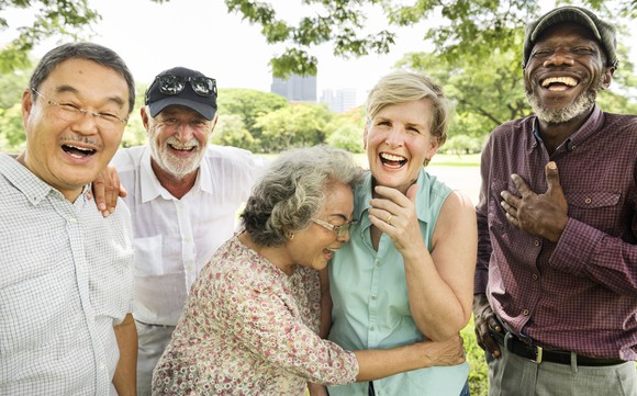 A group of elderly friends laughing