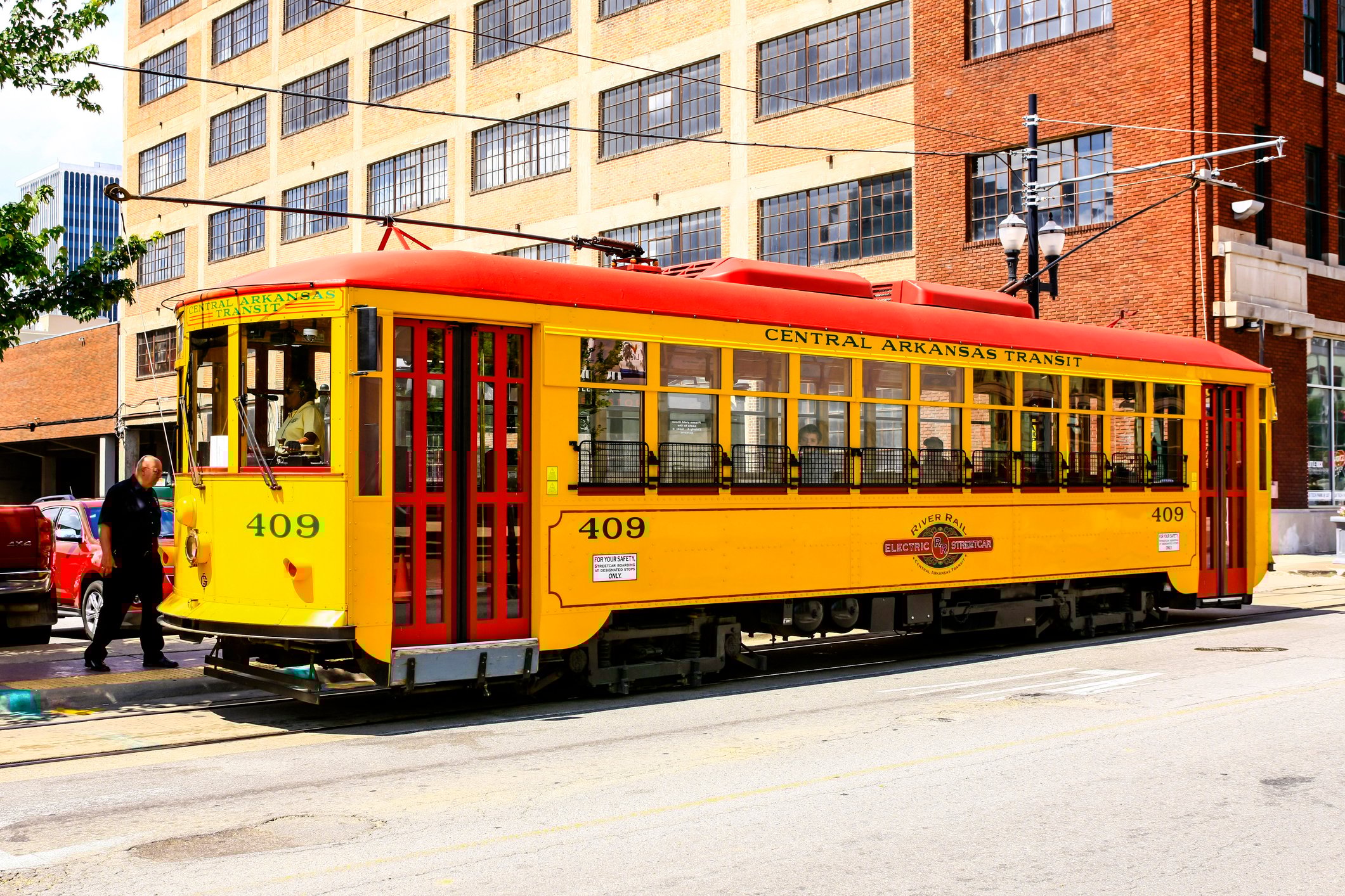 Bright yellow vintage city streetcars in downtown Little Rock Arkansas