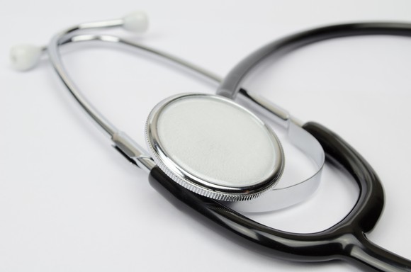 a stethoscope lying on a plain white surface.