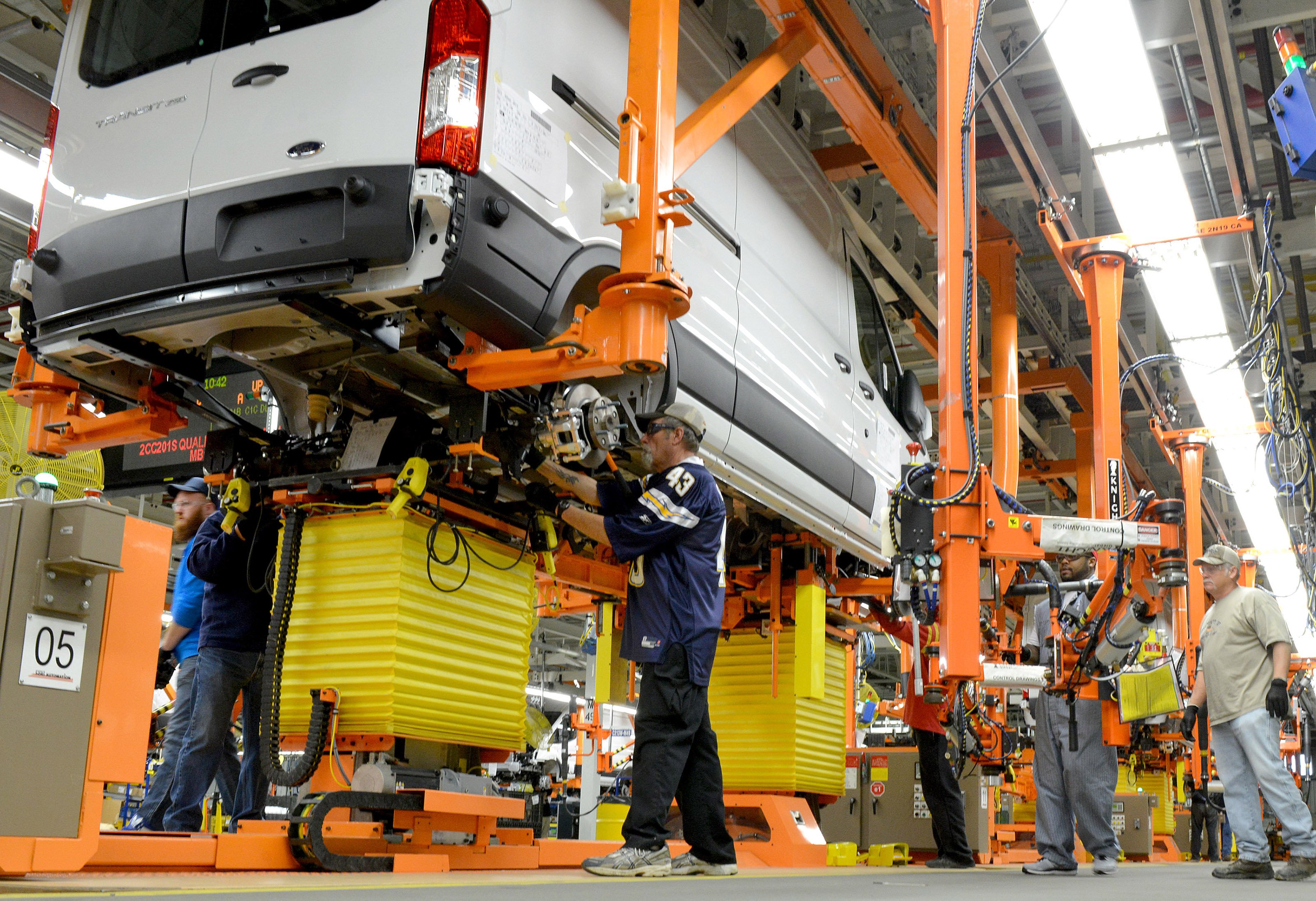 A partially-assembled white Ford Transit van moves down an assembly line at Ford's Kansas City Assembly Plant.