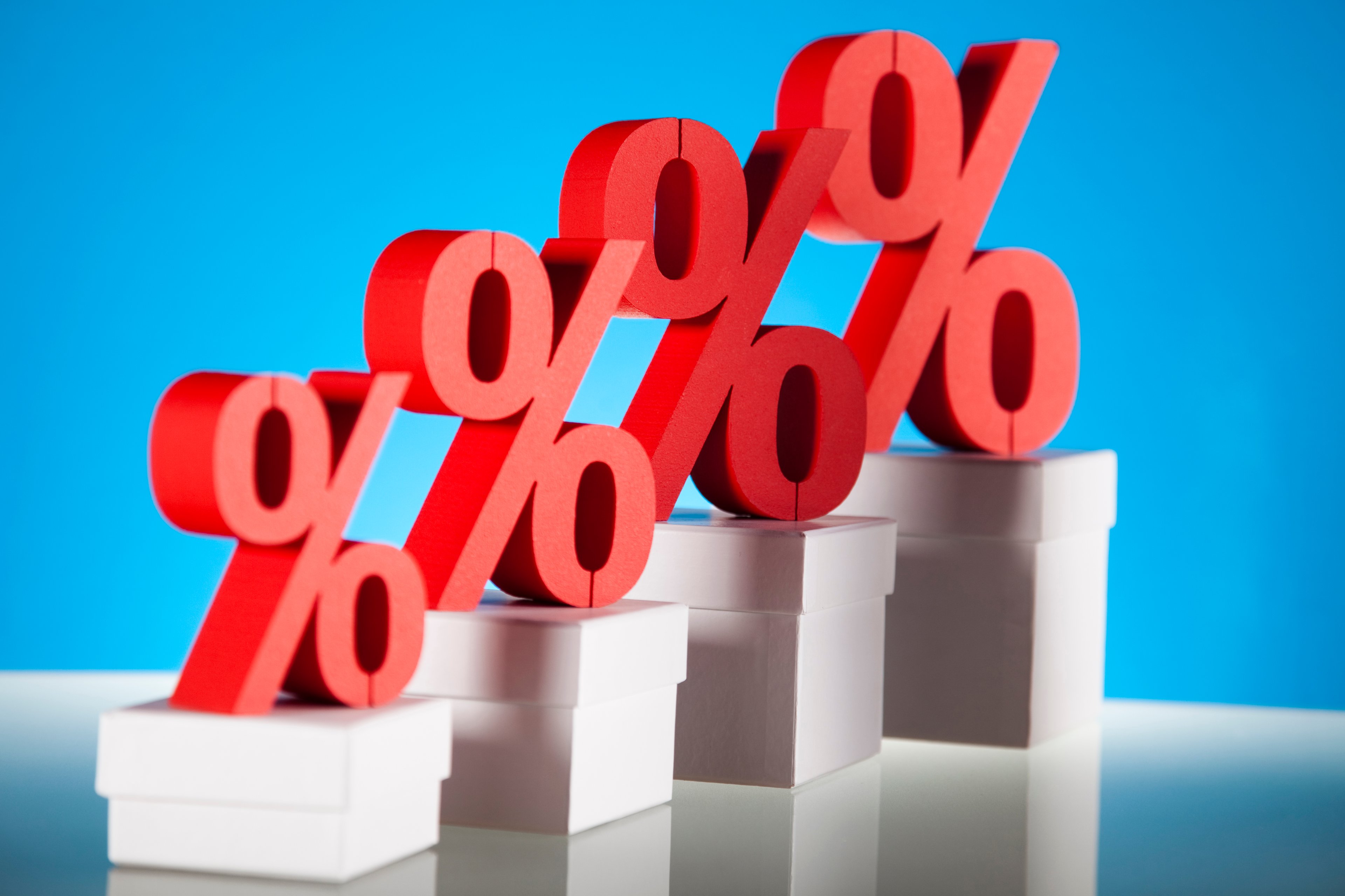 Percentage signs on increasingly taller pedestals. 