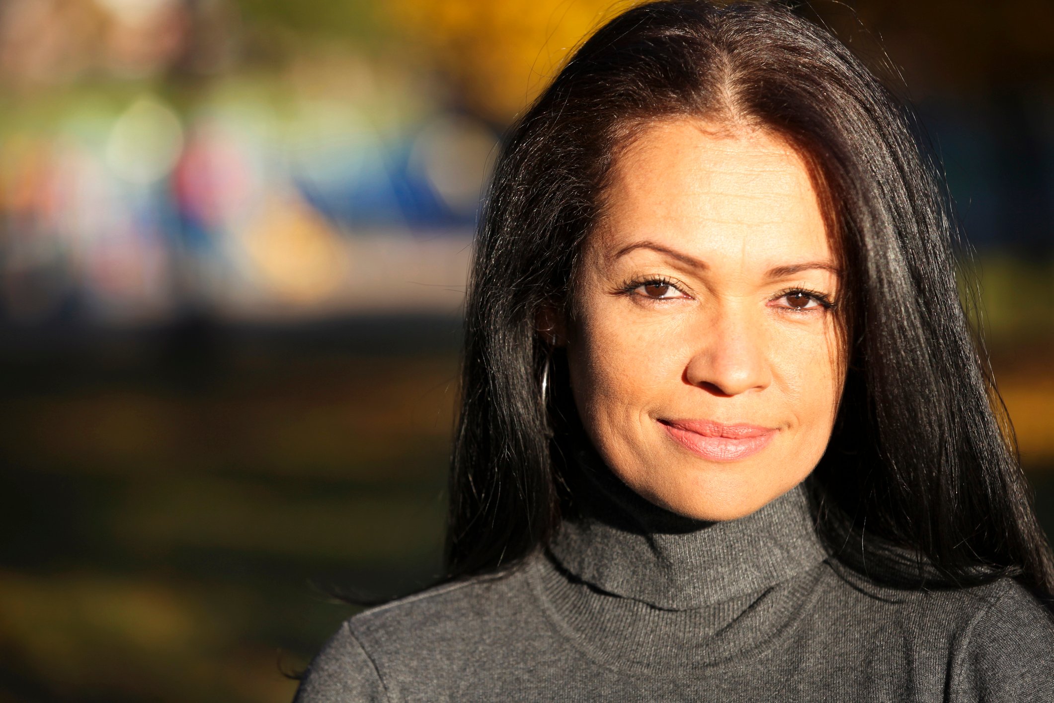 Serious woman with light smile