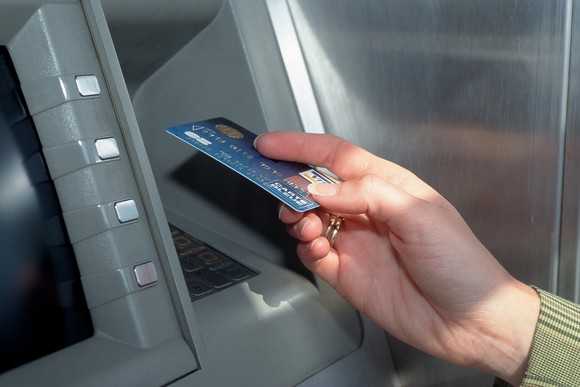 Payment card holder using an ATM