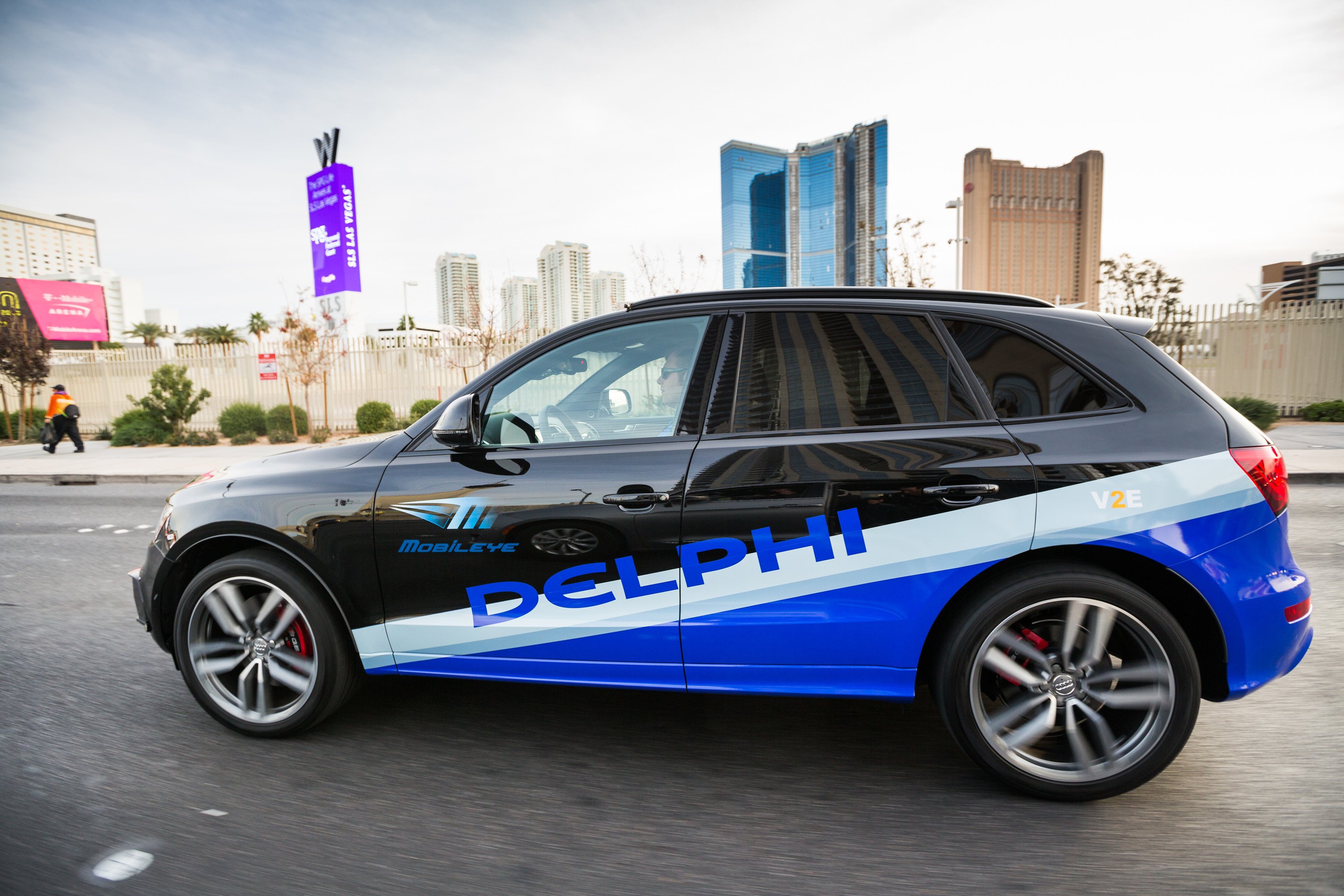 An Audi SUV with Delphi and Mobileye logos is shown driving in Las Vegas.