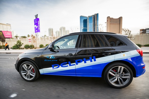 An Audi SUV with Delphi and Mobileye logos is shown driving in Las Vegas.