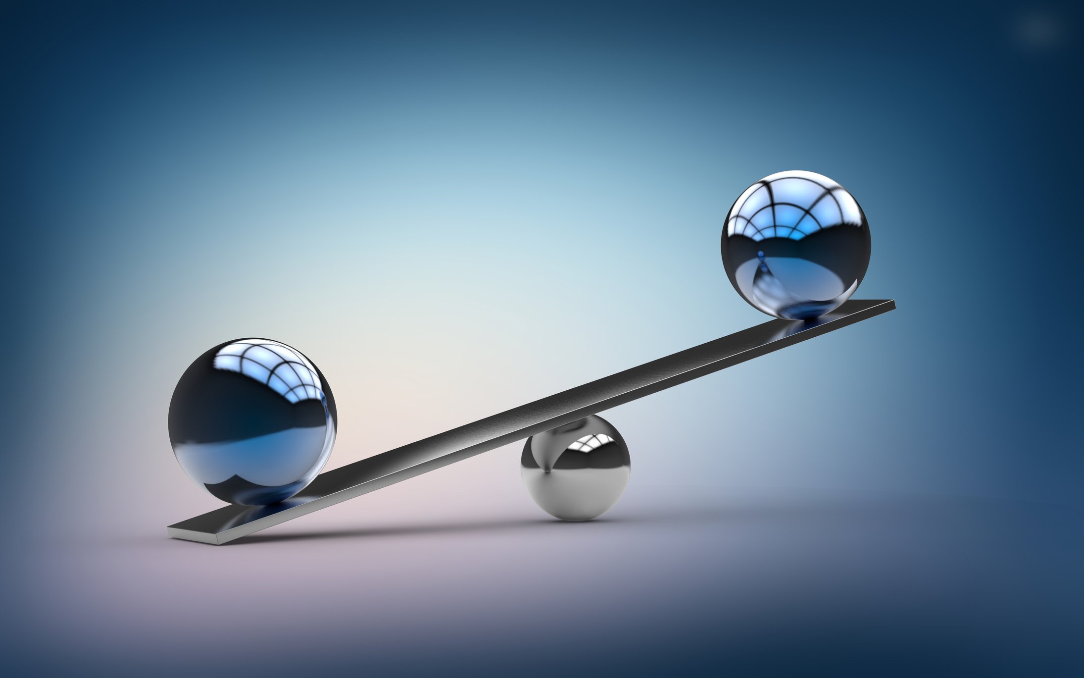 An unbalanced seesaw with two polished spheres sitting at the ends.