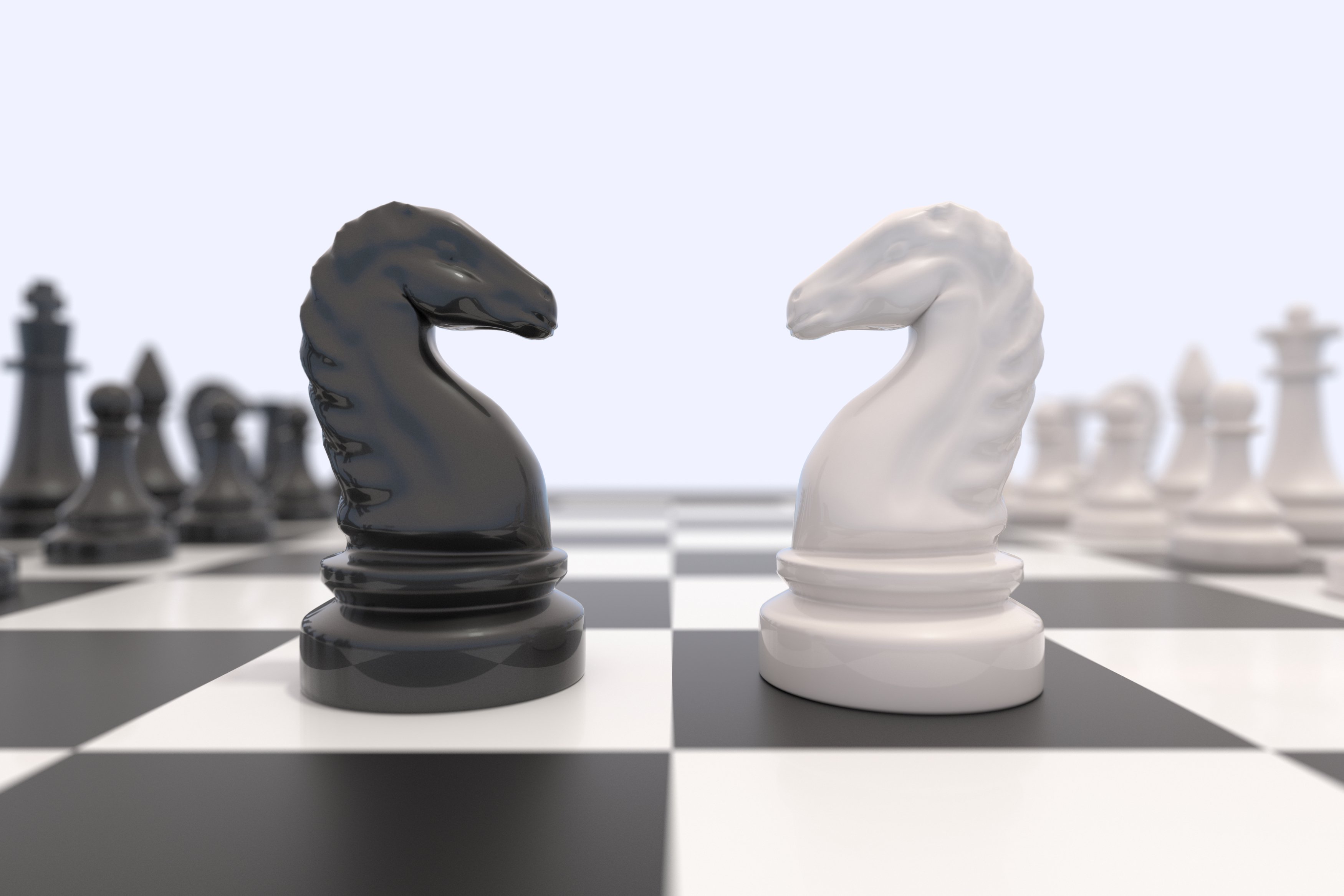 Chess pieces facing off against each other. 