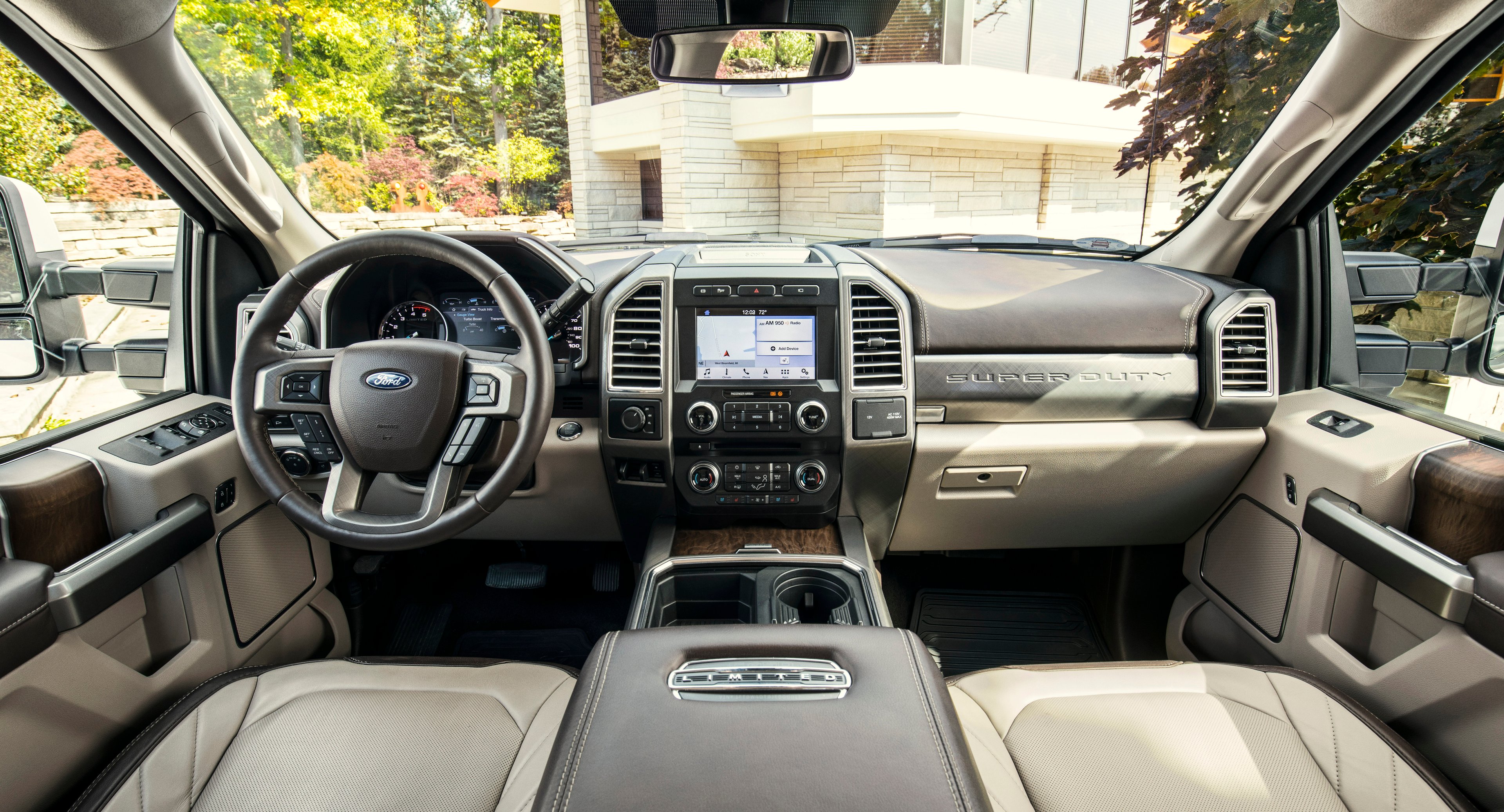 The interior of a 2018 Ford F-450 Limited, with leather seats, wood trim, and a touchscreen system visible.