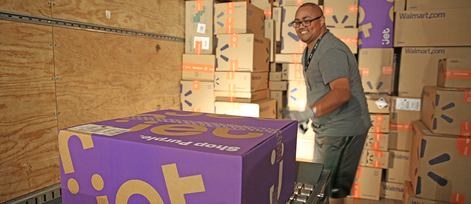 A warehouse worker gets a Jet.com box ready for shipping.