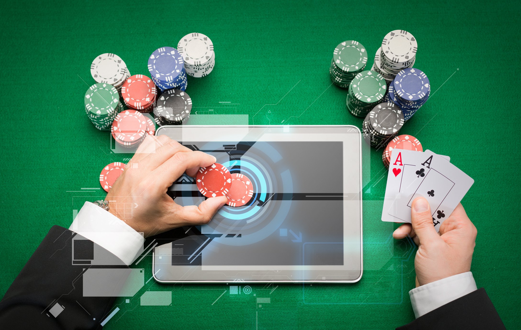Man playing poker with a tablet on the table
