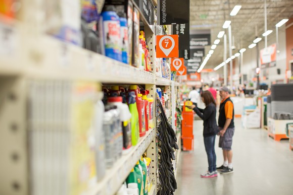 A woman and a staff member are in a Home Depot. 