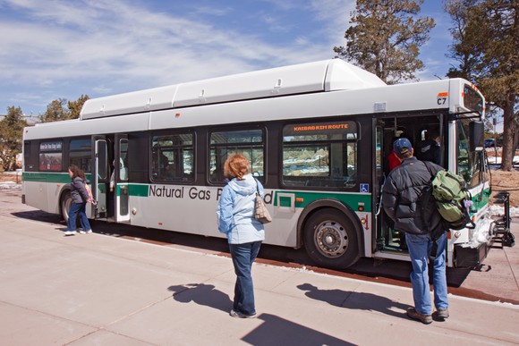 Natural gas bus picking up passengers.