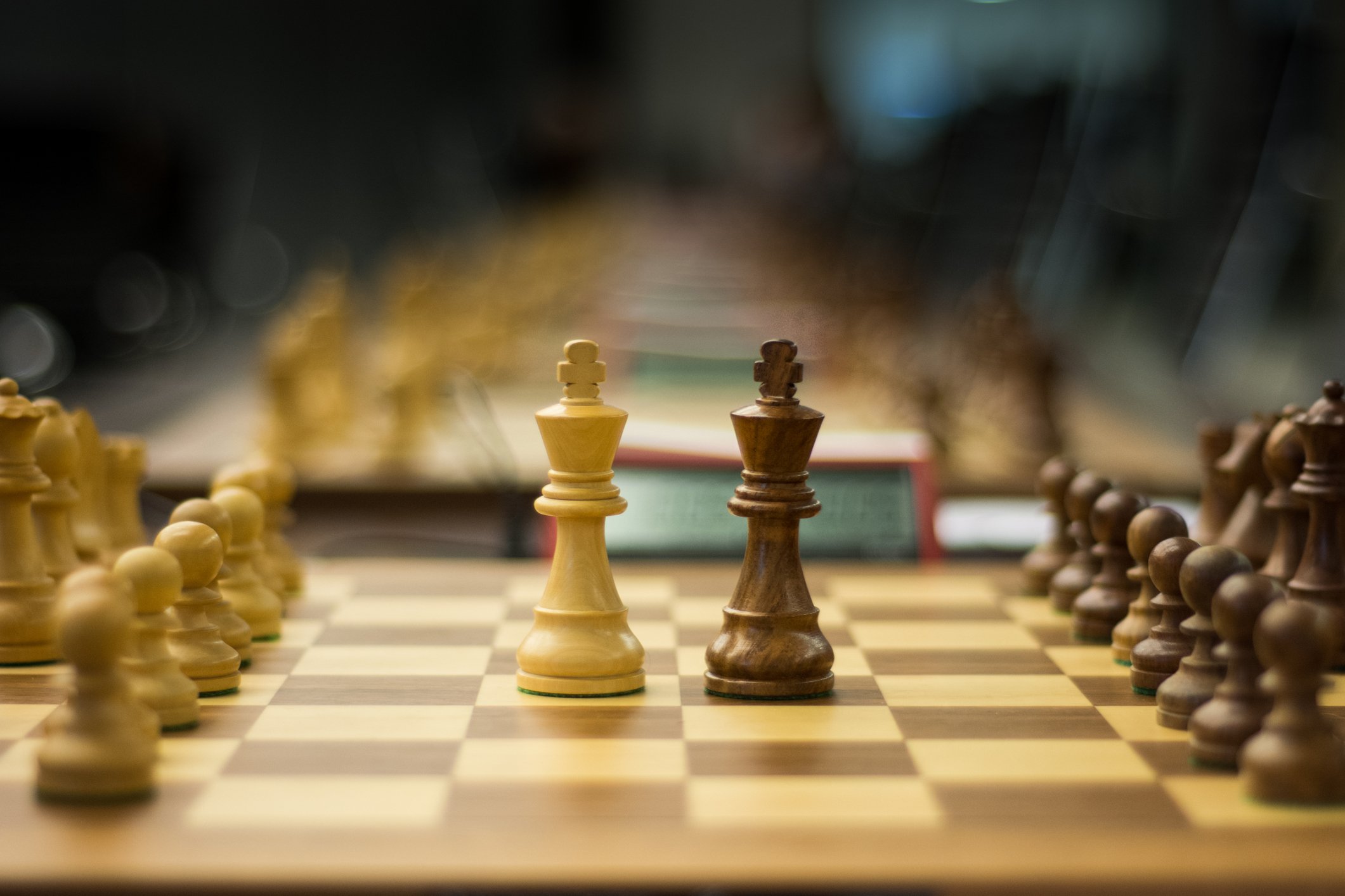 Two chess piece kings on a chessboard adjacent to each other