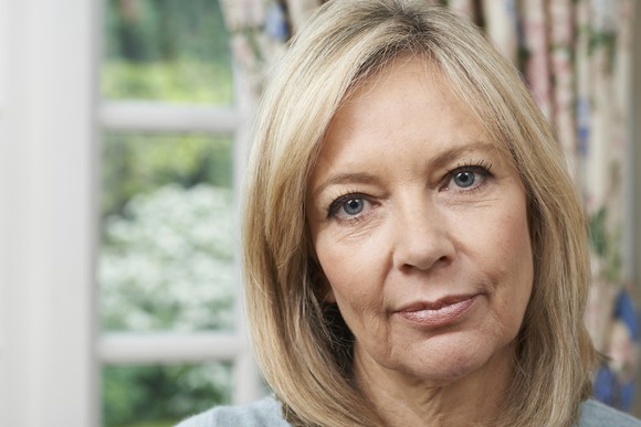 A serious older woman staring at the camera