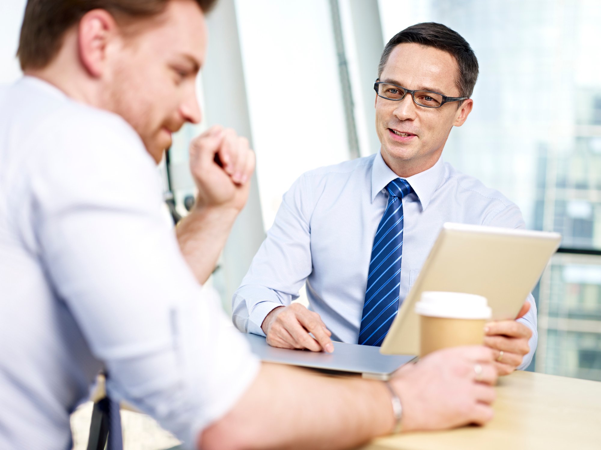 Two professionally dressed men having a discussion