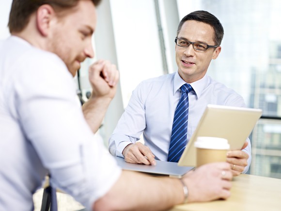 Two professionally dressed men having a discussion