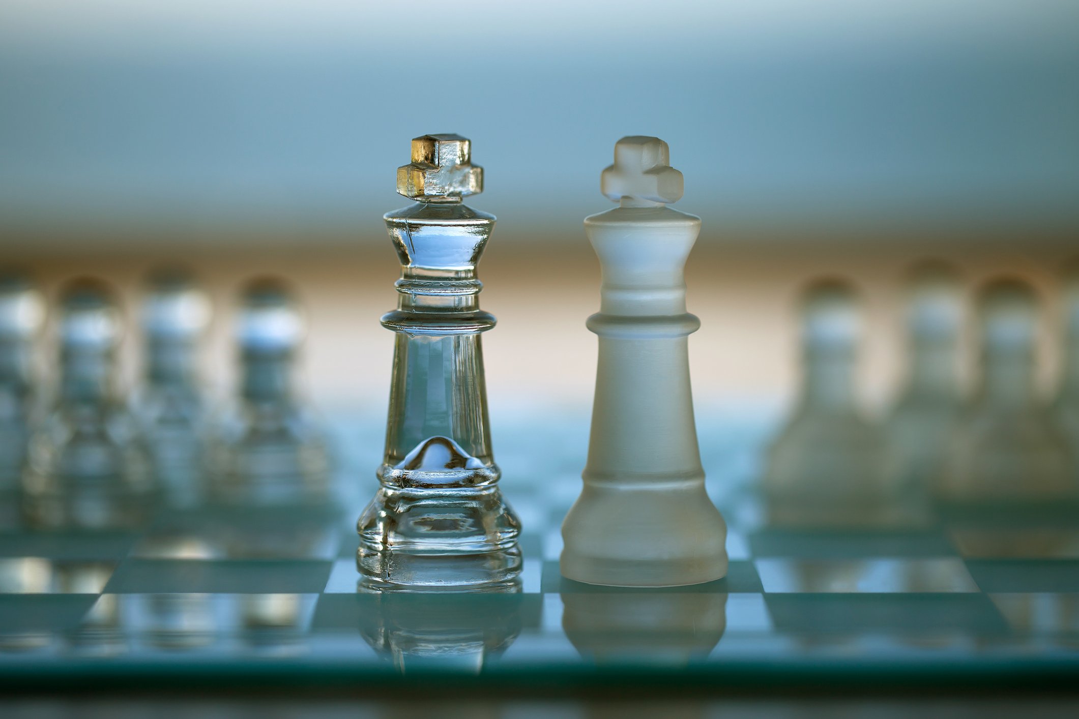 Two chess piece kings facing each other