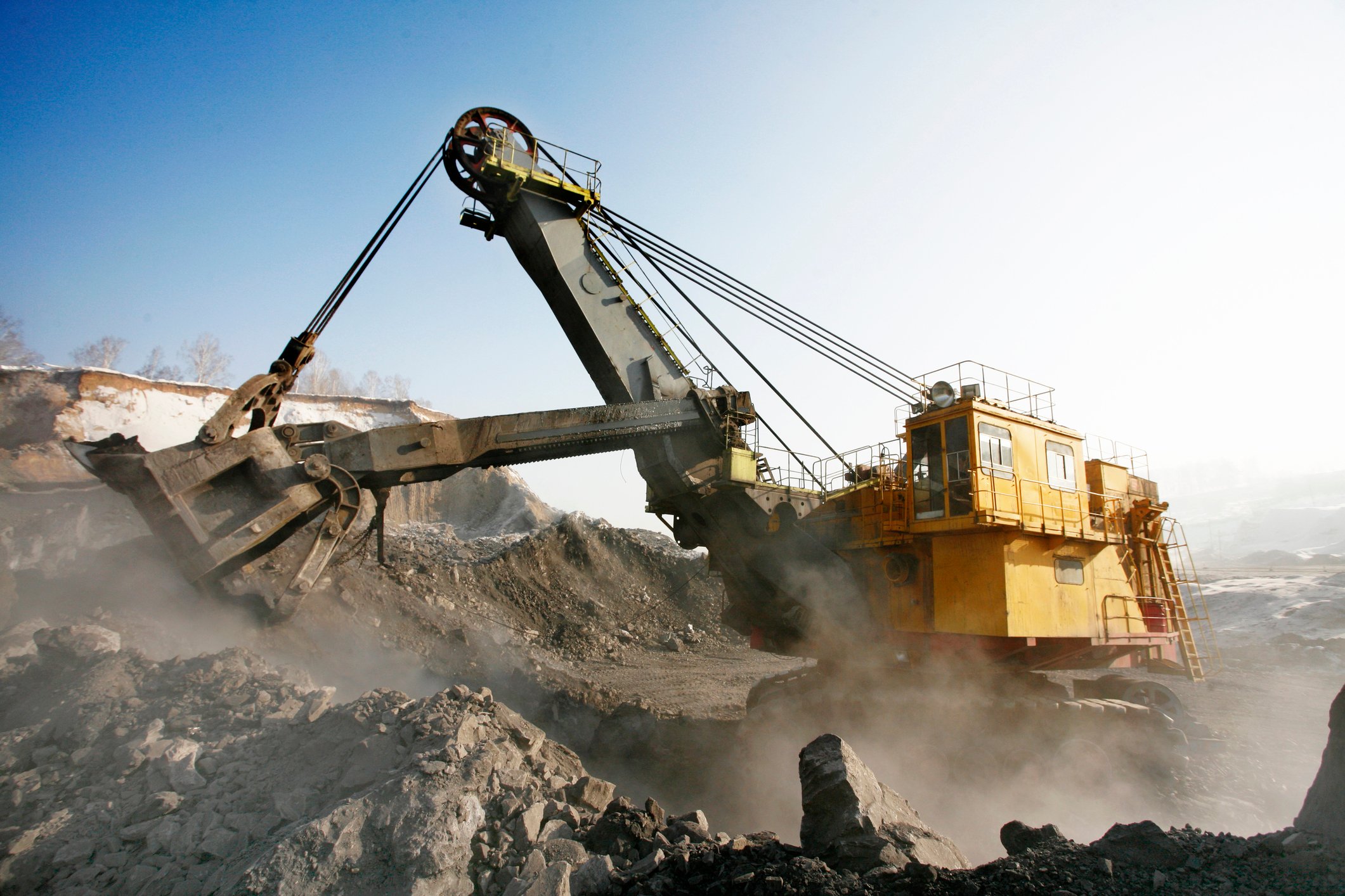 A piece of mining machinery extracting raw ore from a surface level mine.