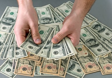 Hands counting a big pile of cash