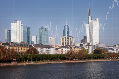 A large cities skyline with a rising stock chart super-imposed over its buildings and skyscraper.