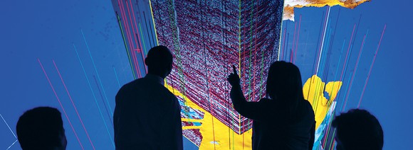 Engineers looking at a geology chart of an energy play.