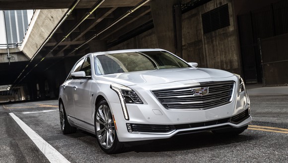 A silver 2018 Cadillac CT6, a full-size luxury sedan, on a road under an overpass.
