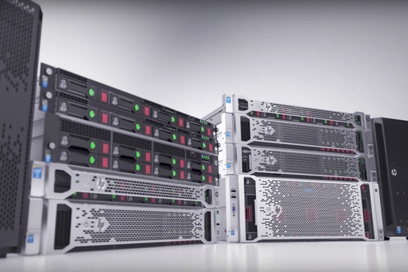 Rack servers up against a white wall in an otherwise empty room.