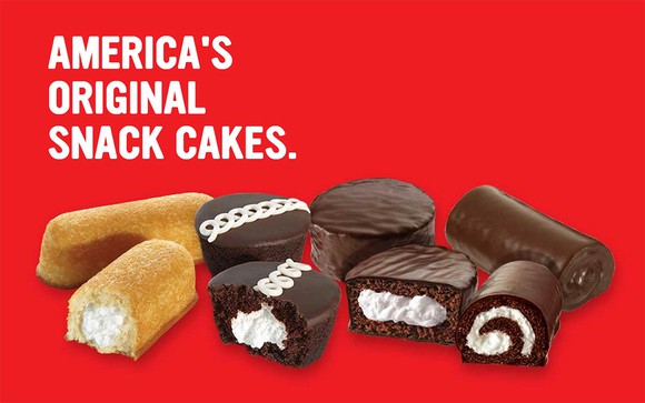Twinkies, Ding Dongs, Ho-Hos, and cupcakes on a red background with "America's Original Snack Cakes" caption.