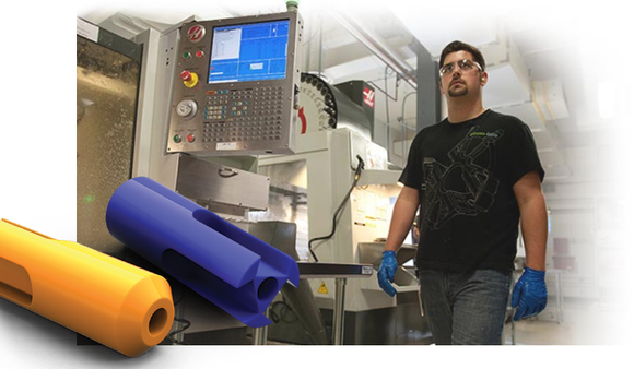 Operator standing in front of a CNC machine.