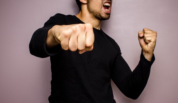 Man punching the air with his fist.