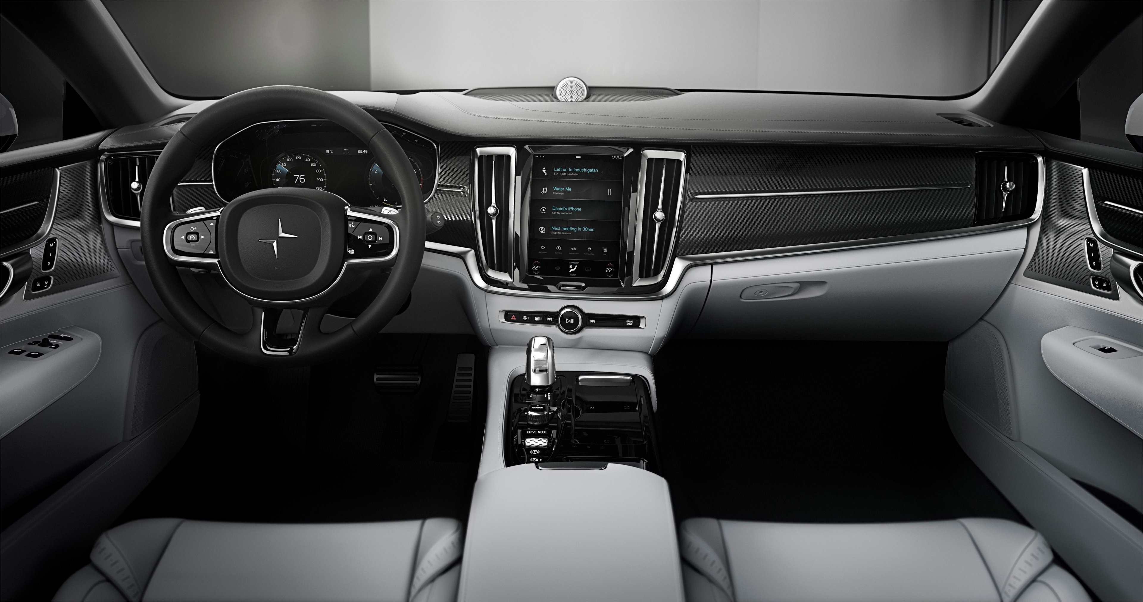 The Polestar 1's front seats and dashboard. Seats are trimmed in gray leather, and the traditional-looking dashboard is trimmed in black.