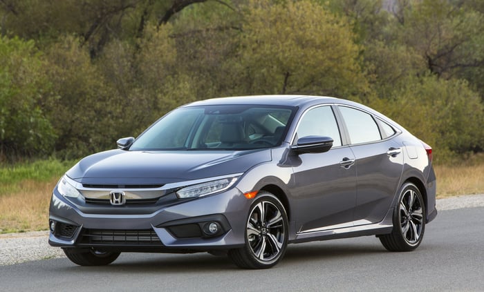 A gray Honda Civic, a compact four-door hatchback. 