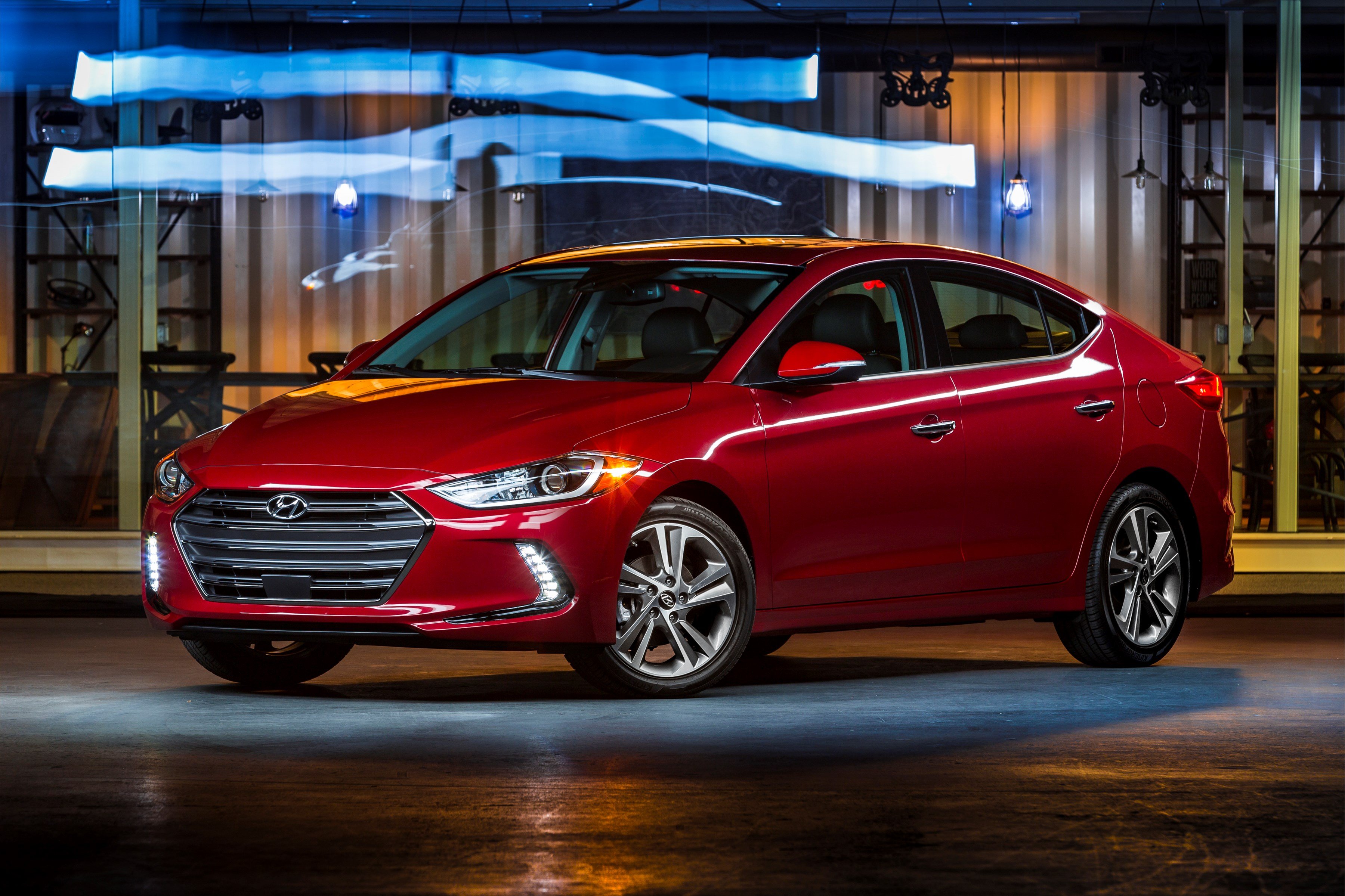 A red Hyundai Elantra compact sedan.